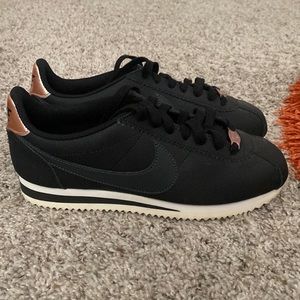 Size 7 black and rose gold Nike Cortez.